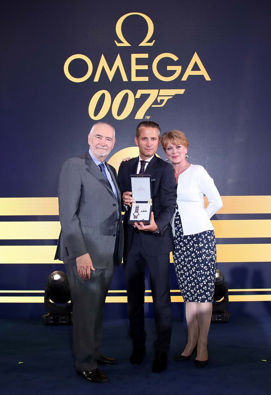 Michael.G-Wilson-Samantha-Bond-Raynald-Aeschlimann-with-watch